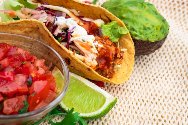 istock Mexican traditional authentic homemade tacos with pulled pork beef chili con carne serve with tomato salad and avocado guacamole and dip sauce 1253304787