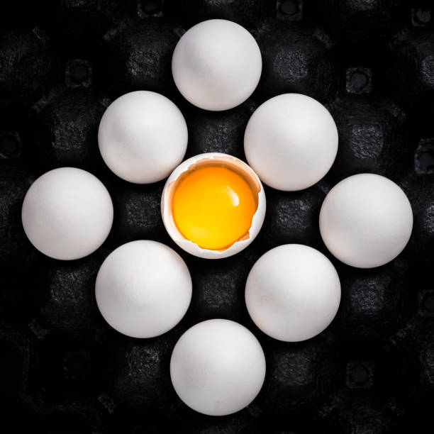 istock White eggs and yolk arrangement stacked in black carboard carrier 1253304985