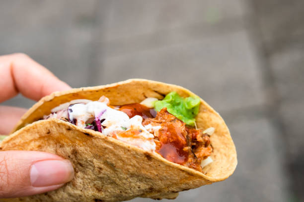 istock Mexican traditional authentic homemade tacos with pulled pork beef chili con carne serve with tomato salad and avocado guacamole and dip sauce 1253305040