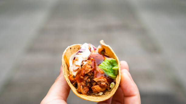 istock Mexican traditional authentic homemade tacos with pulled pork beef chili con carne serve with tomato salad and avocado guacamole and dip sauce 1253305136