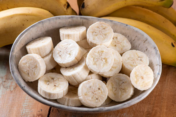 istock Whole and cut bananas in a bowl 1253306561