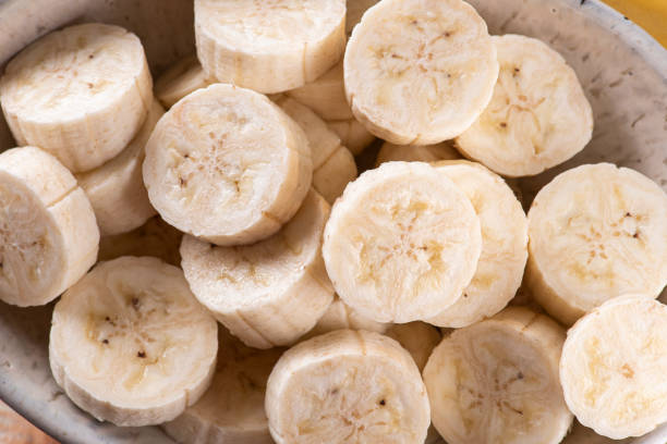 istock Whole and cut bananas in a bowl 1253306731