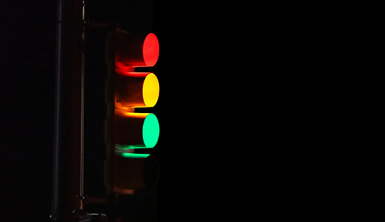 All three lights on the traffic light are lit up in the image.