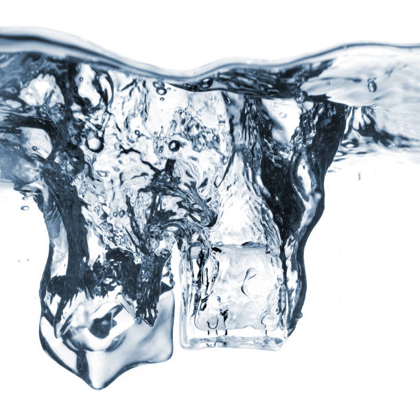 istock ice cubes dropped into water with bubbles isolated on white 1253308526