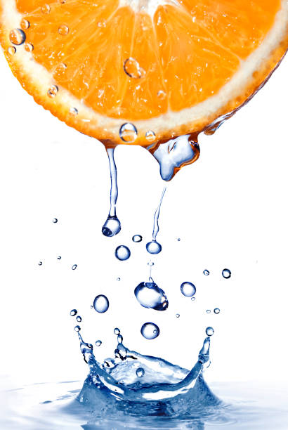 istock fresh water drops on orange with water splash isolated on white 1253308627