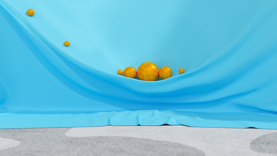 Yellow spheres resting on folds in blue fabric