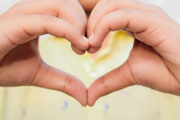 istock Hand Shoot, close up portrait create heart shape from hand 1253311075