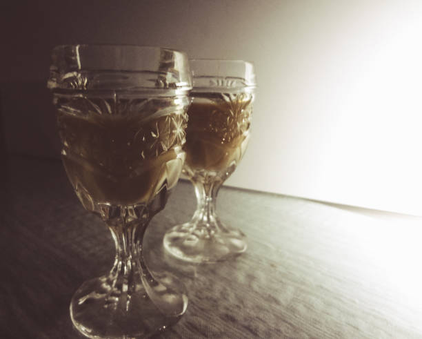 two small  liqueur glasses on bar counter in pup or restaurant - whisky liqueur glass alcohol bottle imagens e fotografias de stock