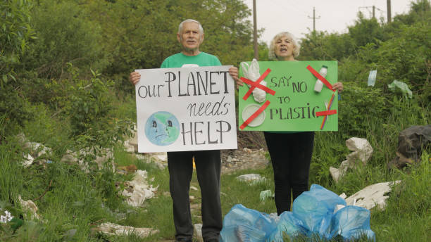 istock Senior volunteers with protesting posters Our Planet Needs Help, Say No To Plastic. Nature pollution 1253311334