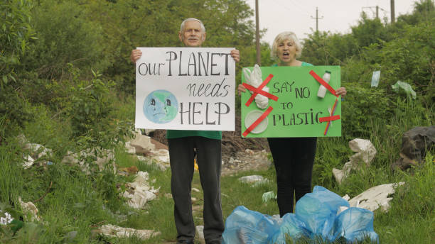 istock Senior volunteers with protesting posters Our Planet Needs Help, Say No To Plastic. Nature pollution 1253311338