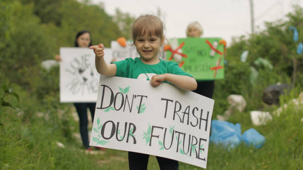 istock Girl volunteer holds protesting poster Don't Trash Our Future. Plastic nature pollution. Recycle 1253311345