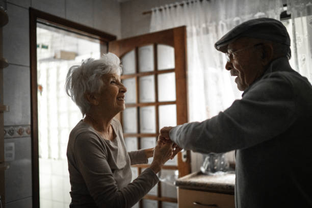 istock Lovely senior couple dancing at home 1253312900