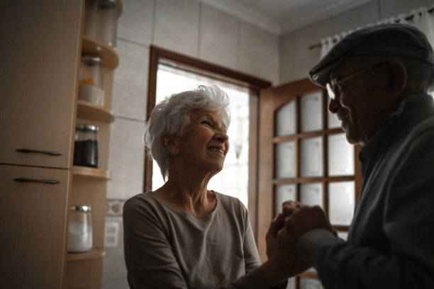 istock Lovely senior couple dancing at home 1253312914
