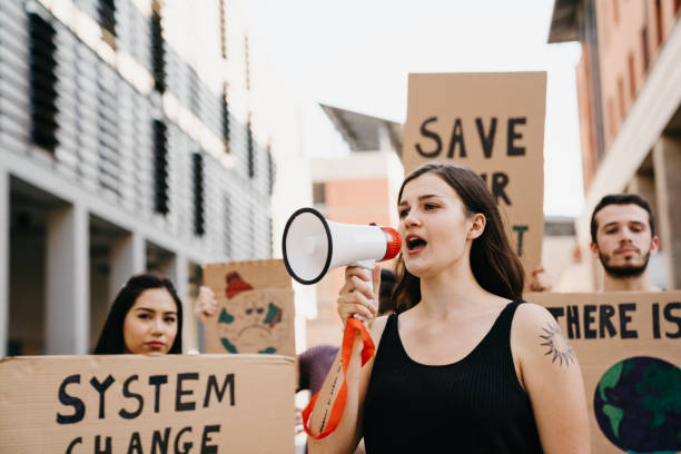 istock Group of people participating in a protest against global warming 1253315250