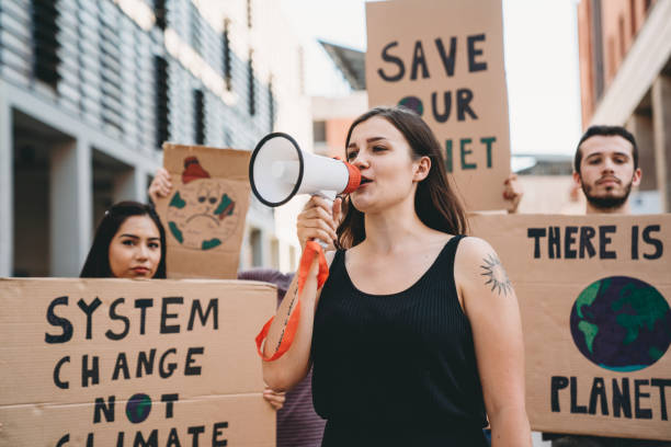 istock Group of people participating in a protest against global warming 1253315257