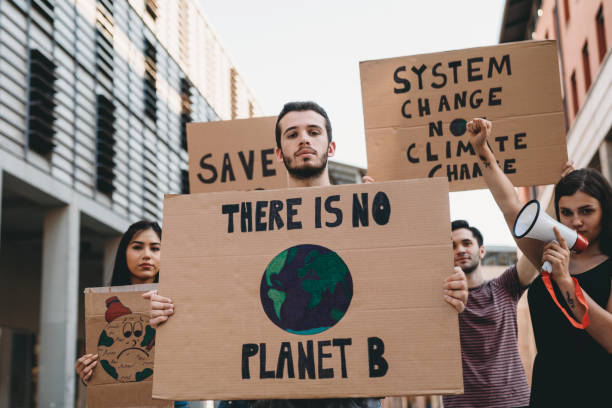 istock Group of people participating in a protest against global warming 1253315311