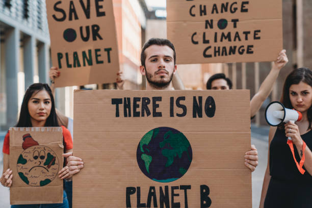 istock Group of people participating in a protest against global warming 1253315323