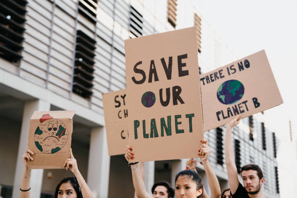 istock Group of people participating in a protest against global warming 1253315329