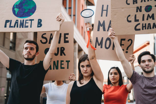 istock Group of people participating in a protest against global warming 1253315355