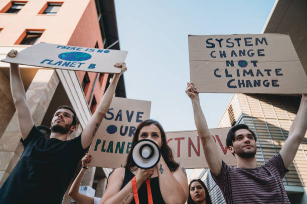 istock Group of people participating in a protest against global warming 1253315381