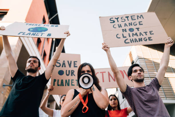 istock Group of people participating in a protest against global warming 1253315394