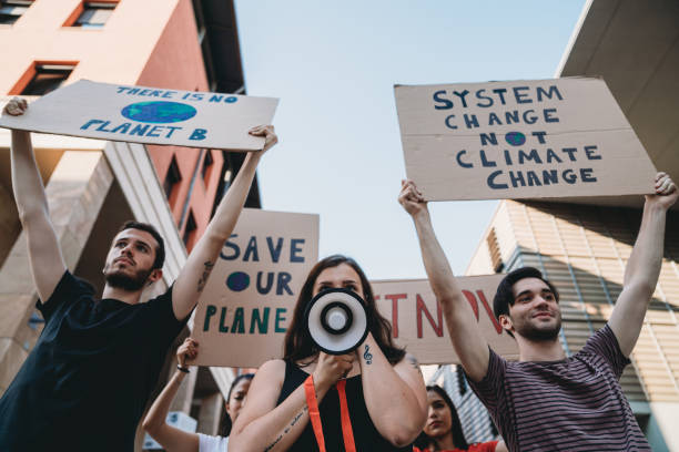 istock Group of people participating in a protest against global warming 1253315403