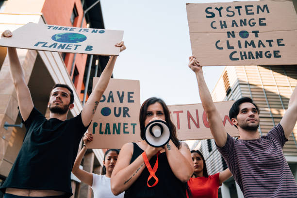 istock Group of people participating in a protest against global warming 1253315418