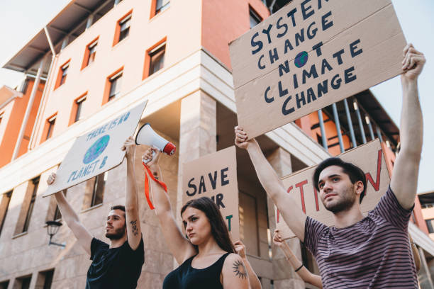 istock Group of people participating in a protest against global warming 1253315469