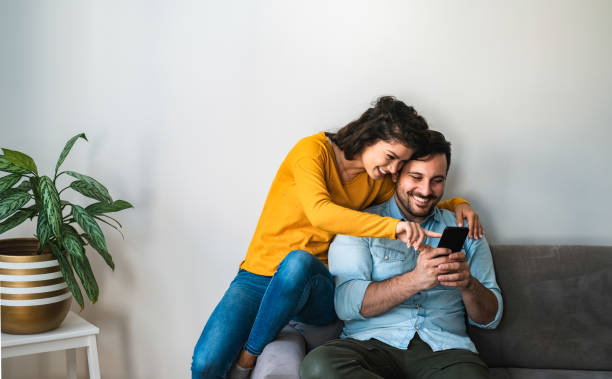 istock Happy couple using phone stock photo 1253318143