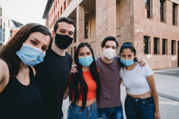 istock Five friends taking a selfie together, wearing facemasks 1253318555