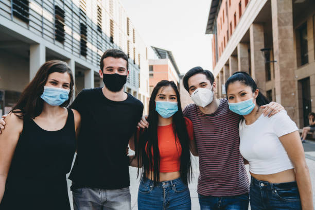 istock Group photo of five friends while they are wearing facemasks 1253318562