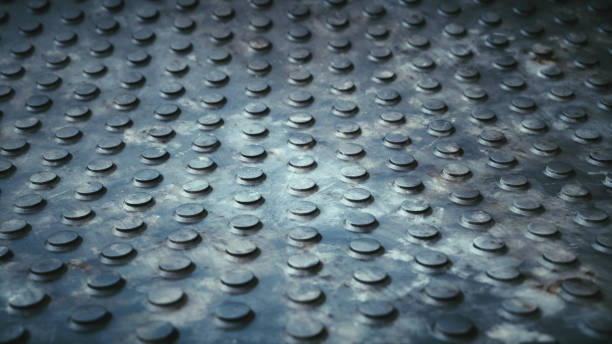 istock Low-angle view on dirty artificial studded ground floor surface with defocused background 1253319789