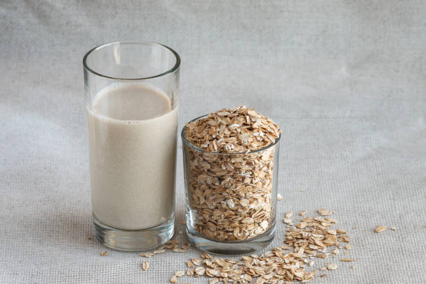 istock Close up oat milk in tall drinking glass with seed 1253321775