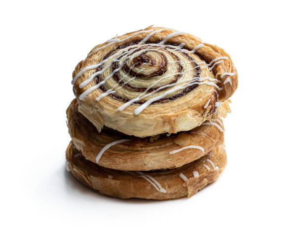 istock Freshly baked traditional cinnamon swirls isolated on white 1253324702