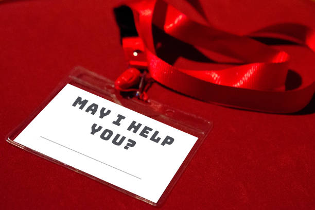 istock MAY I HELP YOU? badge / name tag on red background with a copy space 1253325440
