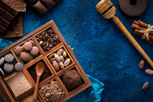 istock Chocolate box with cocoa beans and powder, chololate drops and chocolate beans 1253325898