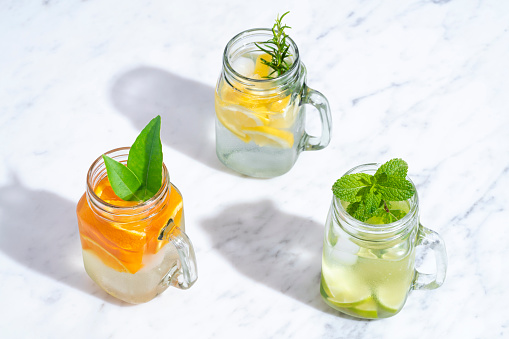Citrus infused water non alcohol cocktails with orange, lemon and lime fruits
