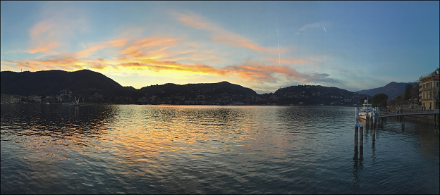 Panoramic picture of the Como lake at sunset. Como is a beautiful tourist city located near the boarder to Switzerland