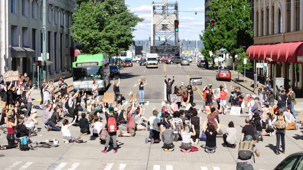 Black Lives Matter Protest March Calling Attention to George Floyd's Death Tacoma, WA/USA  June 1: Street View Protesters create a Mob Scene blocking an intersection for George Floyd and the BLM in Tacoma June 1, 2020 racism photos stock pictures, royalty-free photos & images