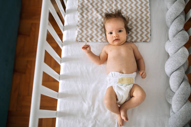 istock Cute baby boy lying in his crib 1253331675
