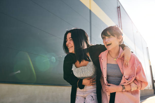 istock Young teenagers laughing outdoors on a sunny day 1253334816