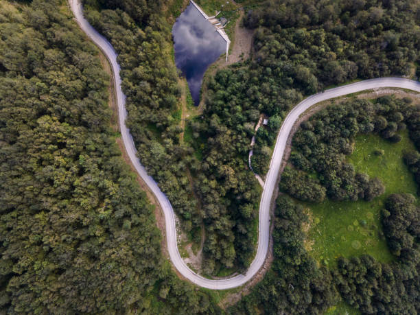 istock Top down aerial view on road with curves between the forest in nature on mountain range - Drone photo forest and asphalt road travel concept - Stara Planina Old Mountain travel destination in Serbia 1253335886