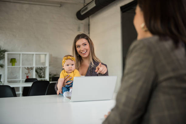 istock Single mother holding her baby girl while talking with her client 1253337737