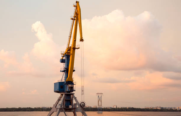 istock View of the river cranes at sunset. Sand mining on the River Dnipro. 1253339102