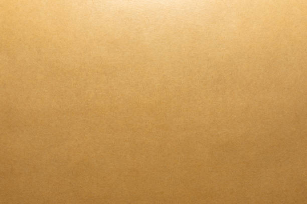 istock Brown background made of real colored paper, illuminated by a soft light from above. 1253340165