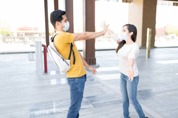 istock Couple Maintaining Social Distance While Greeting 1253340203