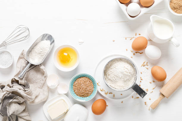 istock Baking homemade bread on white kitchen worktop with ingredients for cooking, culinary background, copy space, overhead view 1253341076