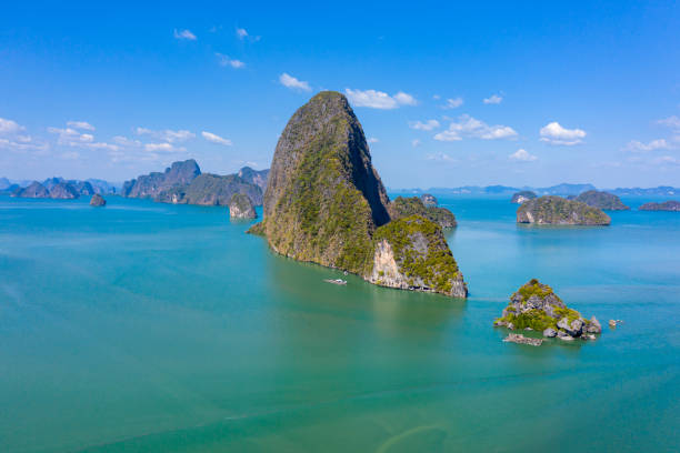 Aerial view of towering limestone islands in a beautiful tropical bay Aerial view of towering limestone islands in a beautiful tropical bay phang nga bay stock pictures, royalty-free photos & images