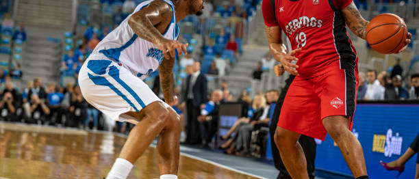 istock Basketball players tackling for ball 1253344230