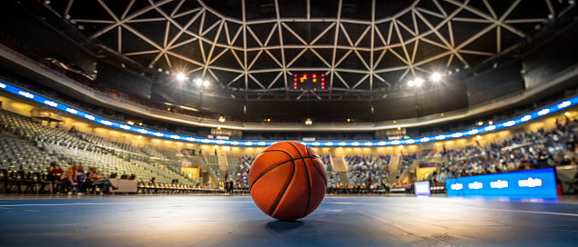 Close-up of basketball on court in stadium.